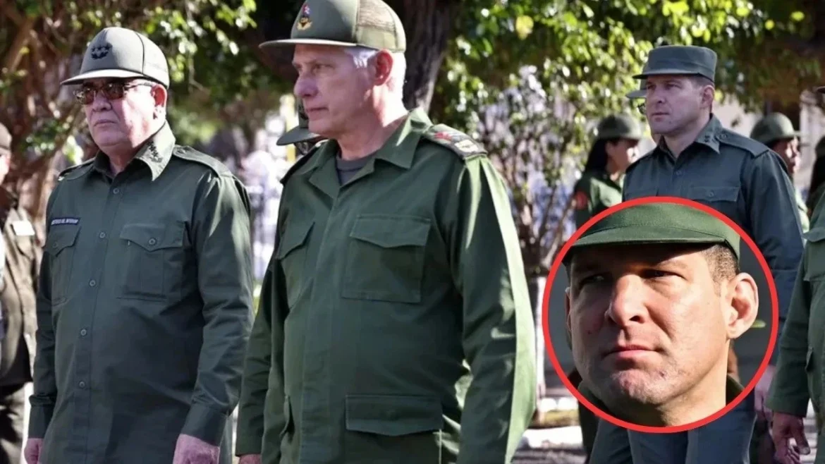 Group of uniformed military personnel standing outdoors in a shaded area with trees in the background.
